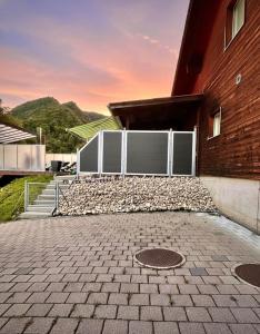 a building with a white gate and a brick building at Cozy Swiss Retreat - Scenic Swiss Villa Close to Bern & Interlaken in Frinvillier +86 photos
