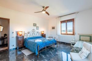 a bedroom with a bed and a ceiling fan at Agriturismo Osea in Monteriggioni
