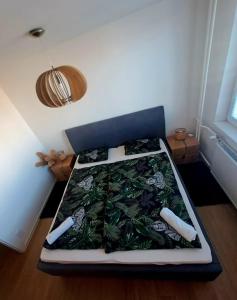 a bedroom with a bed with a plant pattern on it at Lovely flat in a great location in Košice