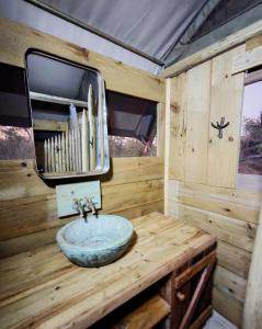 a bathroom with a sink and a mirror at Khanya Conservation Camp in Phalaborwa