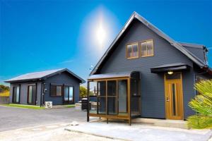a black house with a yellow door at BOTH ISUMI - Vacation STAY 06710v in Isumi