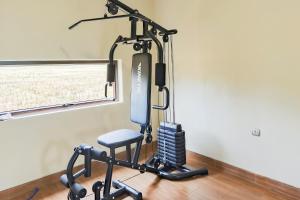 a treadmill room with a chair and a mirror at Urbanview Hotel JD Luxury Brebes in Banjararja +31 photos
