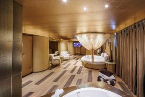 a hotel room with a bed and a bathroom at Ruby Rooms Kifisia in Athens