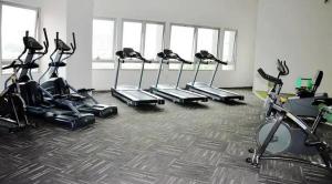 a gym with a bunch of exercise bikes in a room at Taragon Puteri Bintang KLCC View Studio Apartment in Kuala Lumpur