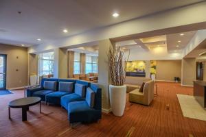 a lobby with blue couches and a living room at Country Inn & Suites by Radisson, Convention Center in Altoona