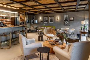 a restaurant with chairs and tables and a bar at Il Mansio Vegan Hotel and Restaurant in Desenzano del Garda