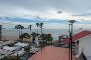 a balcony with a view of the ocean and a beach at Jomtien Wave Residence in Jomtien Beach