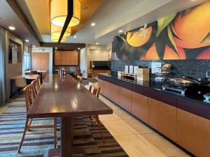 a large kitchen with a wooden table and chairs at Country Inn & Suites by Radisson, Bismarck-Mandan in Bismarck