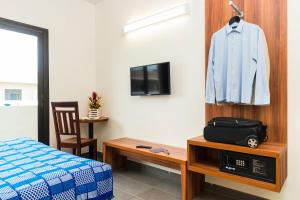 Televízia a/alebo spoločenská miestnosť v ubytovaní ONOMO Hotel Lomé