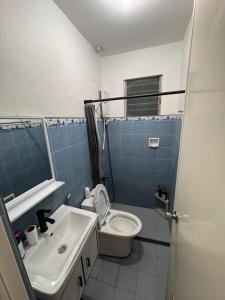 a bathroom with a toilet and a sink at RKs Cozy Balai in General Santos +24 photos