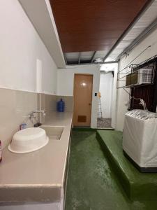 a room with a sink and a room with a door at RKs Cozy Balai in General Santos