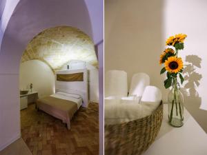 1 dormitorio con 1 cama y un jarrón de girasoles en La casa del nonno, en Matera