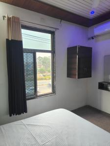 a bedroom with a bed and a window at hotel pink city in Rīngas +12 photos