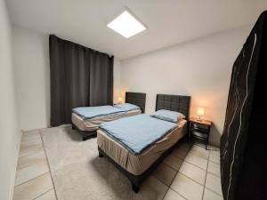 a room with two beds and a window in it at Gästehaus Wohnung #3 in Jülich