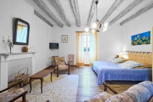 a bedroom with two beds and a living room at Gite La Bessede - Dordogne in La Chapelle-Aubareil