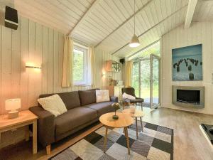 a living room with a couch and a table at Schatzkiste - Dorf Ferienhaus 08 in Priwall