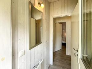 a hallway with a mirror on the wall and a hallway sidx sidx at Schatzkiste - Dorf Ferienhaus 08 in Priwall +55 photos