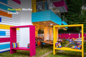 a colorful house with two chairs and a table at goSTOPS Goa, Baga in Baga