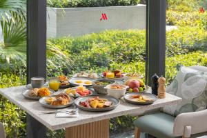 a table full of food on top of a table at Suzhou Marriott Hotel Yangcheng Lake in Suzhou