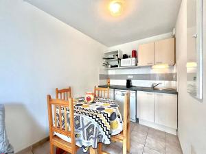 a small kitchen with a table and a kitchen gmaxwell gmaxwell gmaxwell gmaxwell gmaxwell gmaxwell gmaxwell at Panorama du mas, 2 Pers Piscine à Calvisson in Calvisson +15 photos