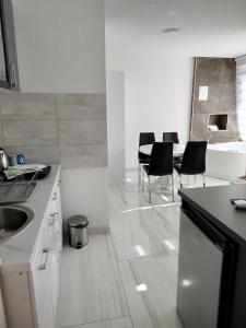 a kitchen with a table and chairs in it at Lela lux in Jošanička Banja