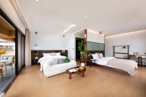 a hotel room with two beds and a table at Shangri La cuckoo hotel in Shangri-La