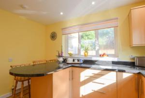 a kitchen with a counter top and a window at Stunning Coastal Home - Garden, Views, Pet Friendly in Connel