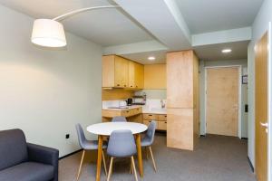 a room with a table and chairs and a kitchen at 1BR apart 1 min from M Kokhta 3rd floor in Bakuriani