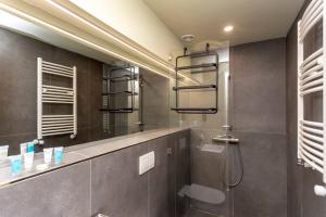 a bathroom with a shower and a mirror at 1BR apart 1 min from M Kokhta 3rd floor in Bakuriani