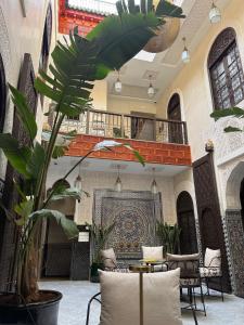 a lobby with a table and chairs in a building at Riad Citronnier & Spa in Fez