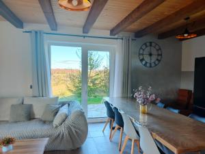 a living room with a table and a couch at Aroniowe Wzgórze in Berezka