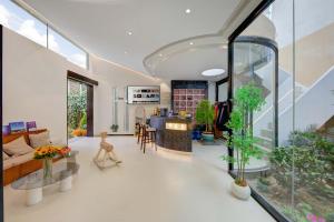 a living room with a lot of plants in it at Shangri La cuckoo hotel in Shangri-La