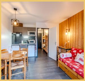 a living room and kitchen with a table and a couch at Le Paradisio I Studio I Morzine in Morzine
