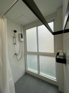 a bathroom with a shower and a window at Namasstay Silom in Chinatown +16 photos