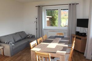 a living room with a table and a couch at Chalupa pod Lysou horou in Ostravice