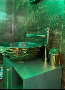 a glass bowl on top of a bathroom sink at Gold Glass z Jacuzzi &Sauną Rynek Centrum in Kielce