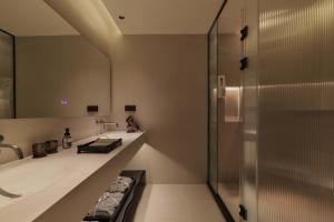 a bathroom with a shower and a sink at Return Courtyard Hotel in Chengdu +89 photos