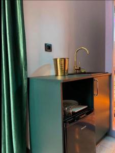 a kitchen with a counter with a sink and a stove at Gold Glass z Jacuzzi &Sauną Rynek Centrum in Kielce +31 photos