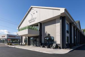 a building with a sign on the front of it at Oakfield Hotel & Suites, an Ascend Collection Hotel in Rochester