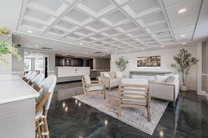 a living room with a couch and a table and chairs at Oakfield Hotel & Suites, an Ascend Collection Hotel in Rochester