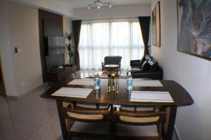 a living room with a table and a couch at KLCC Pavilion Bukit Bintang Agile Hornbill Suites TRX in Kuala Lumpur