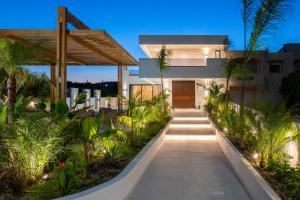 a pathway leading to a house with plants at Lanik Luxury Pool Villa in Afantou