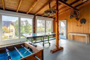 a ping pong table in a room with wooden walls at Ferienwohnung Agnes in Rappersweier