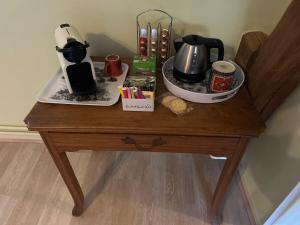 a table with a coffee maker on top of it at La Gentilhommière in Rogerville +7 photos