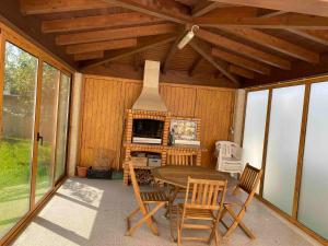eine Terrasse mit einem Tisch, Stühlen und einem Kamin in der Unterkunft Bed and breakfast - Caminha, Portugal in Caminha