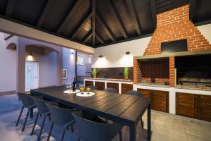 a kitchen with a dining room table and chairs at Villa Lucy Apartments I in Vir