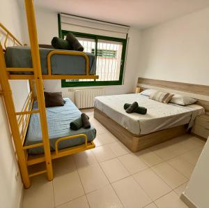 a bedroom with two bunk beds and a ladder at Apartamento 1 con Piscina en Llança in Llança
