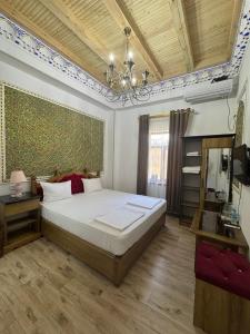 a bedroom with a large bed and a chandelier at Asia Central Boutique in old city in Bukhara +34 photos