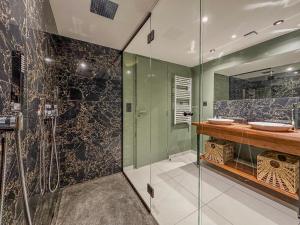 a bathroom with two sinks and a glass shower at Le Refuge de la Bastille - Jacuzzi in Grenoble