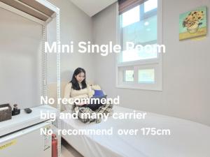 a woman sitting in front of a mirror at Hostel Tommy Renewal 2025 in Seoul +57 photos